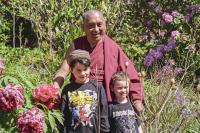 Lama Zopa Rinpoche with children at Chenrezig Institute, Australia, 1994. 
