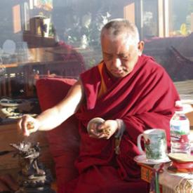 Lama Zopa Rinpoche making offerings to Dorje Khadro, a deity associated with purification.